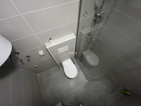 High-angle view of the bathroom with a toilet and a shower cabin. - image 7