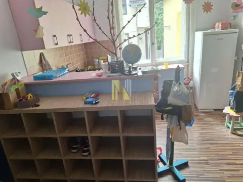 Smaller kitchen connected with storage space and a desk. - image 5