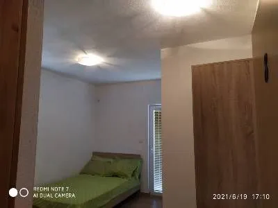 Smaller bedroom with a double bed and access to the terrace. - image 7