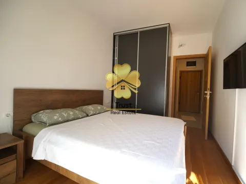 Furnished bedroom with a double bed, wardrobe, and TV. - image 6