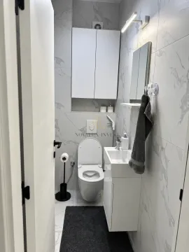 Savremeno opremljeno kupatilo sa bijelim pločicama i ugradnim elementima. - image 9