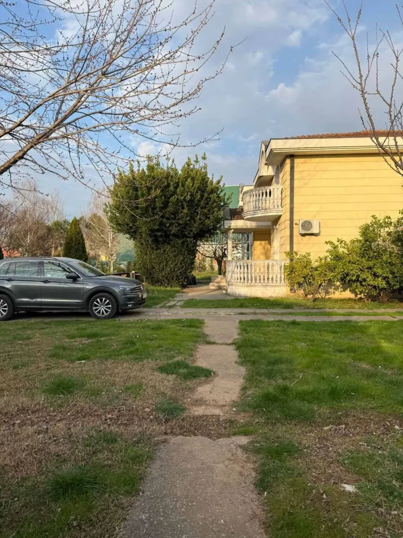 Yard and part of the house facade with a lawn.