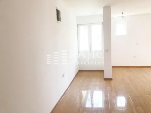 Empty bright room with parquet flooring and white walls. - image 9