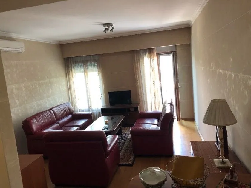Living room with leather sofas and a television.