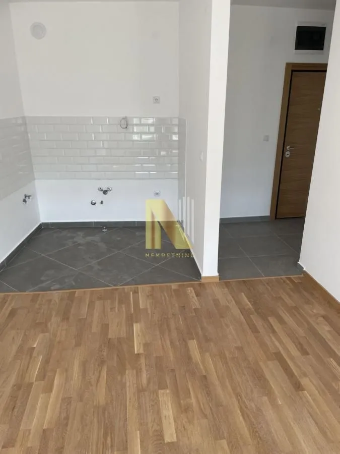 Empty kitchen space under construction with ceramic tiles.