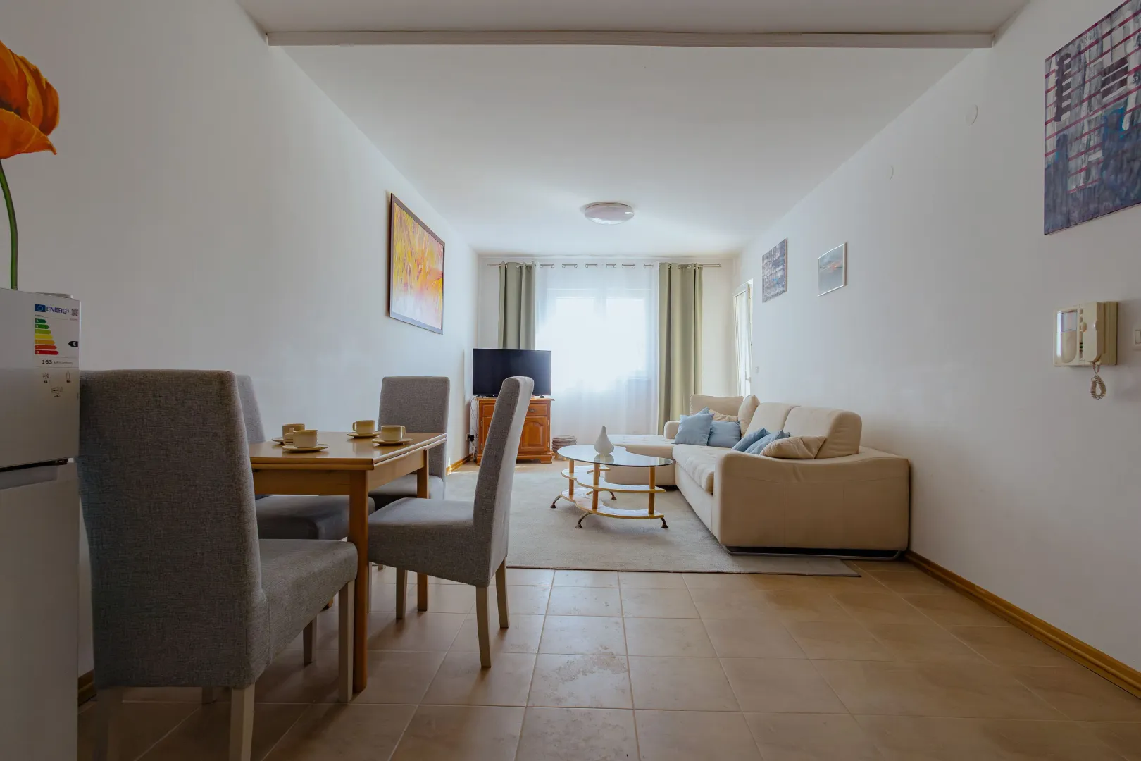 Living room with a dining table and sofa set.