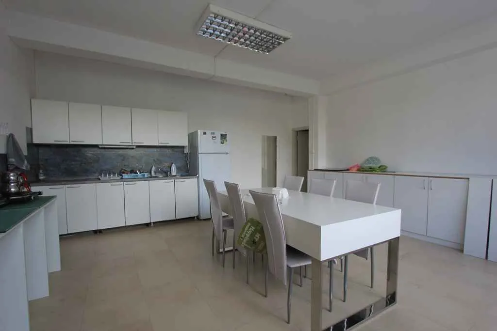Kitchen with dining area and white furniture.