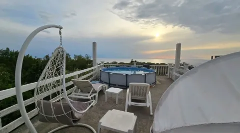 Roof terrace with a pool, loungers, and a sea view. - image 2