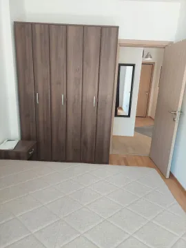 Furnished bedroom with a large wardrobe and a double bed. - image 9