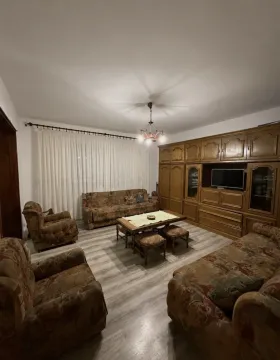 Living room with a seating set and a large wooden wardrobe. - image 3