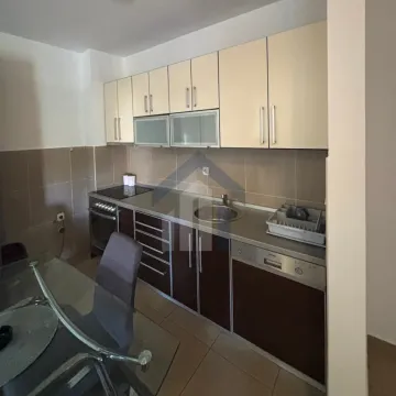 Kitchen with brown and cream cabinetry and a dining table. - image 5