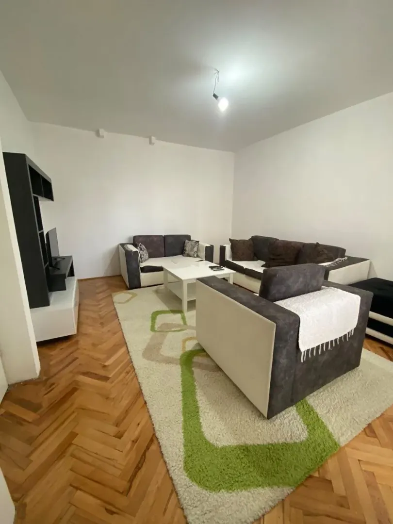 Living room with a seating set, coffee table, and TV unit.