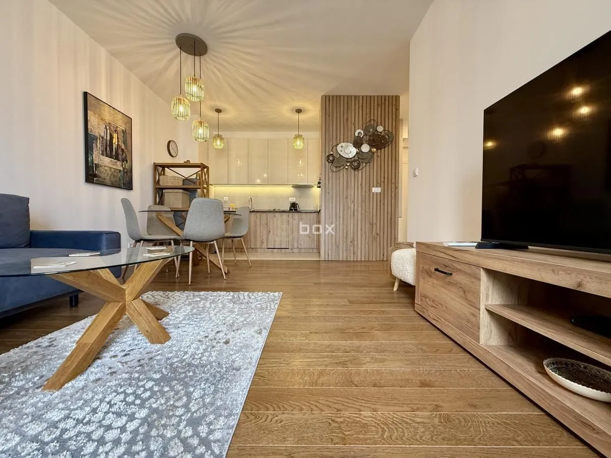 Living room with dining area and kitchen in an open space.