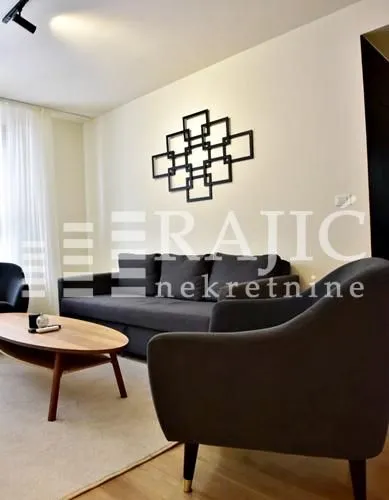 Living room with a sofa set and decorative wall detail.