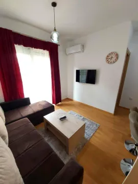 Bright living room with a brown sofa and a wooden coffee table. - image 3