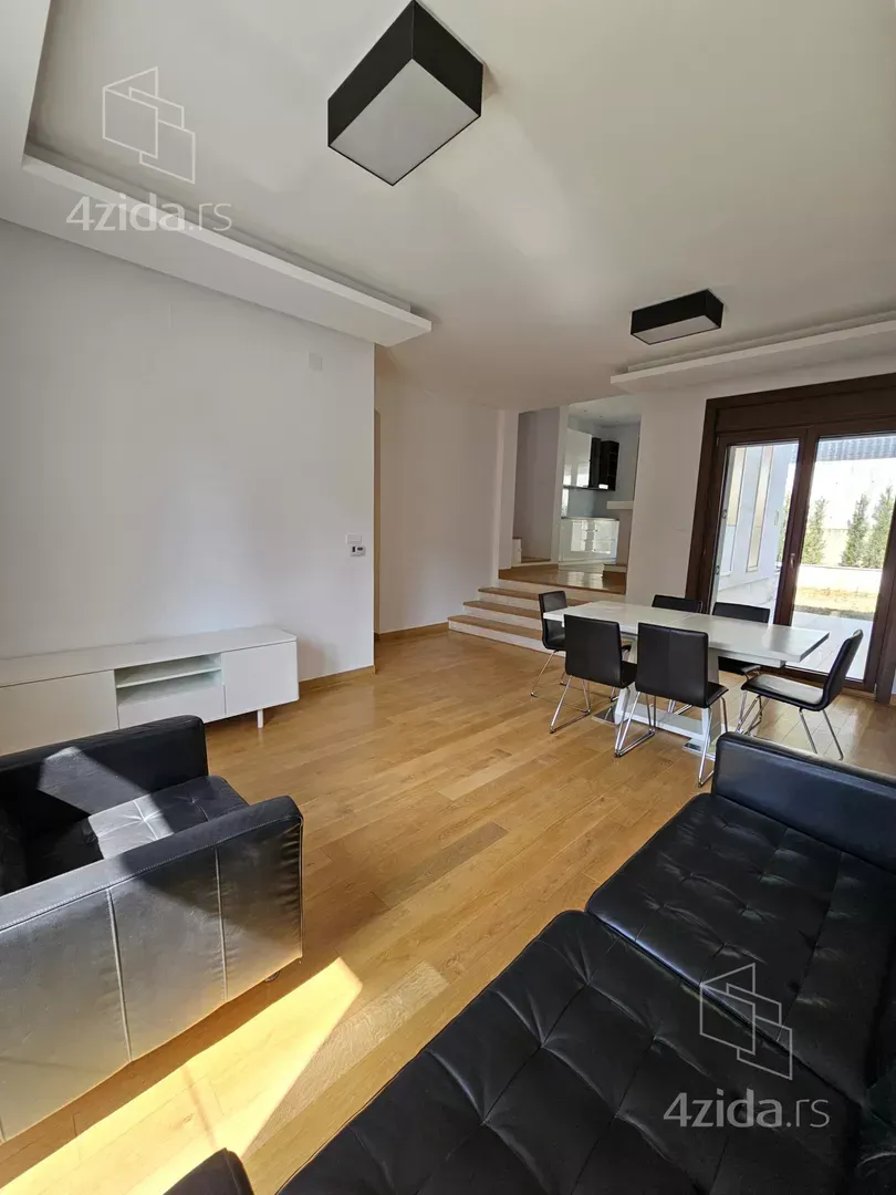 Spacious living room with seating set and dining area.