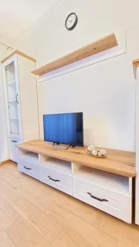 Living room with a TV unit and wall shelf. - image 7