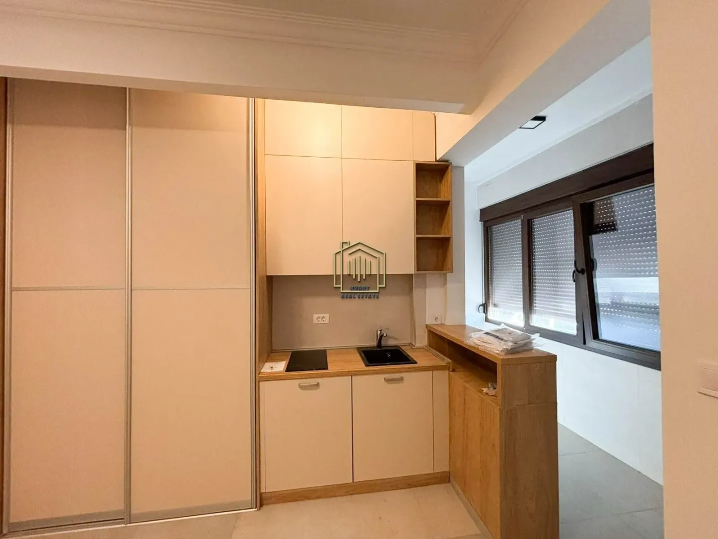 Smaller kitchen with built-in units and a sink.