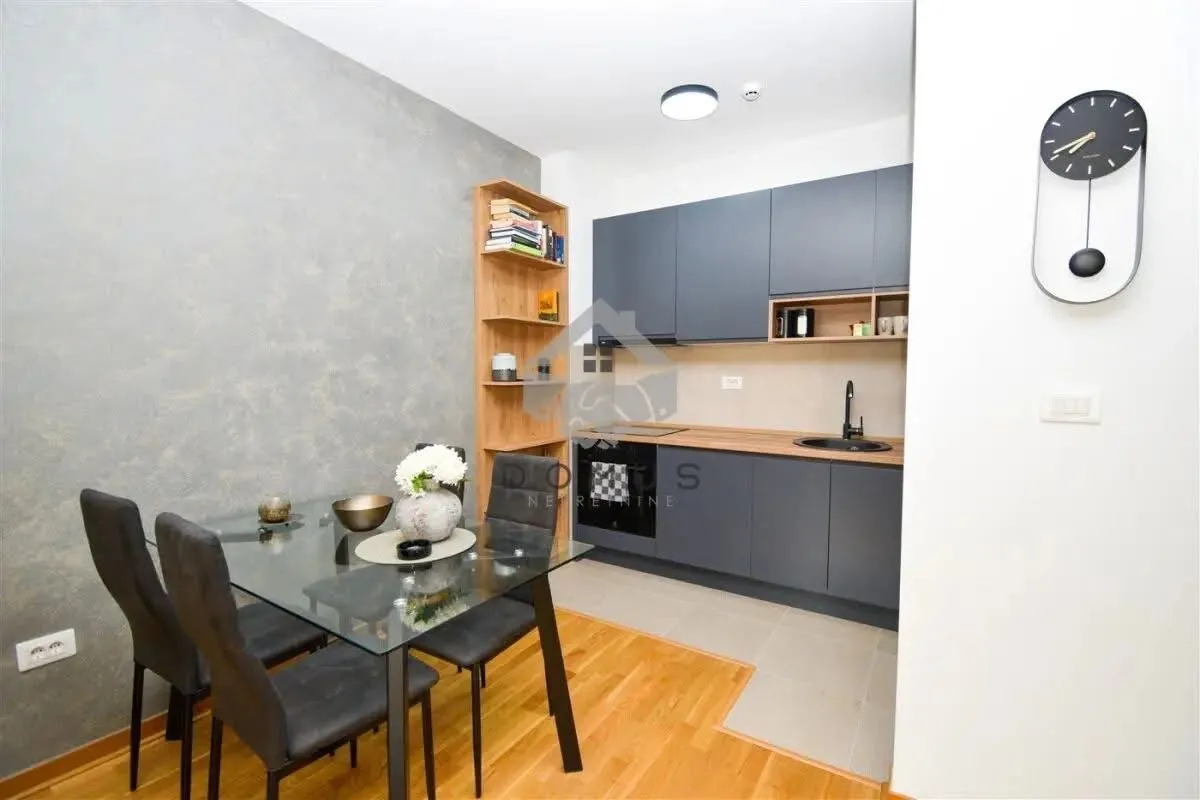 Small kitchen with a dining area and dark cabinets.