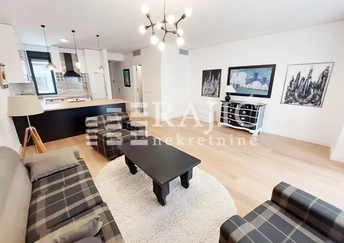 Spacious living room connected to the kitchen in bright tones.