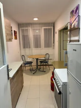 Small kitchen with a dining table and chairs by the window. - image 7