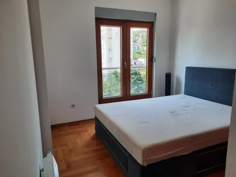 Bedroom with a double bed and a window overlooking greenery. - image 9