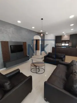 Spacious living room with a sofa set and TV unit connected to the kitchen. - image 17