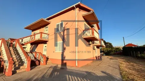 View of the exterior of a two-story house with an external staircase and balconies. - image 3