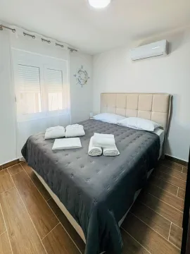 Bedroom with a double bed, air conditioning, and a window. - image 17