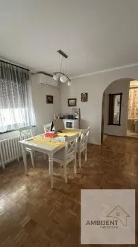 Dining area with a dining table and chairs within the living room space. - image 2