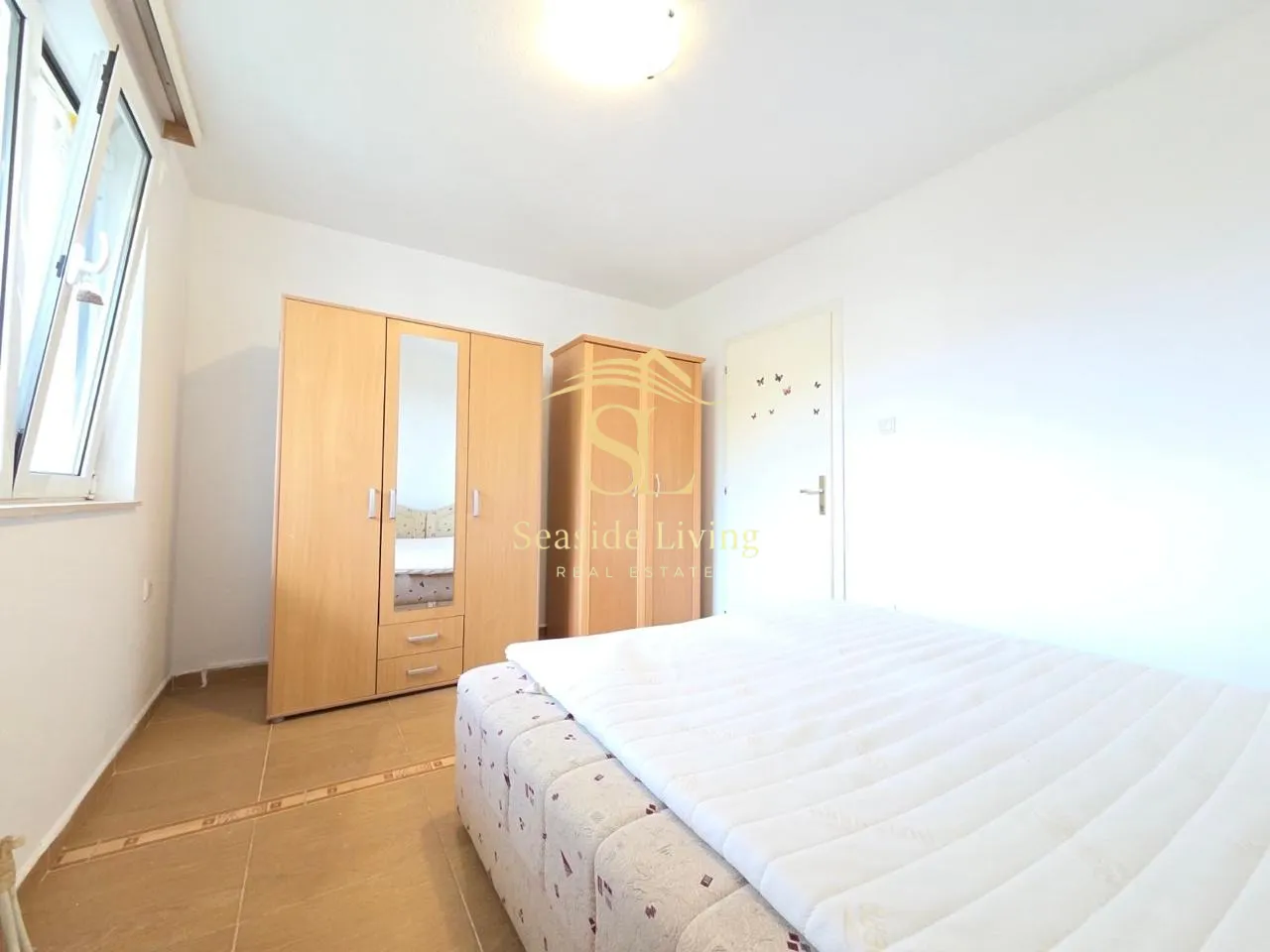 Furnished bedroom with wardrobes and a double bed.