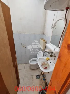 Smaller bathroom with a toilet, sink and mirror. - image 6