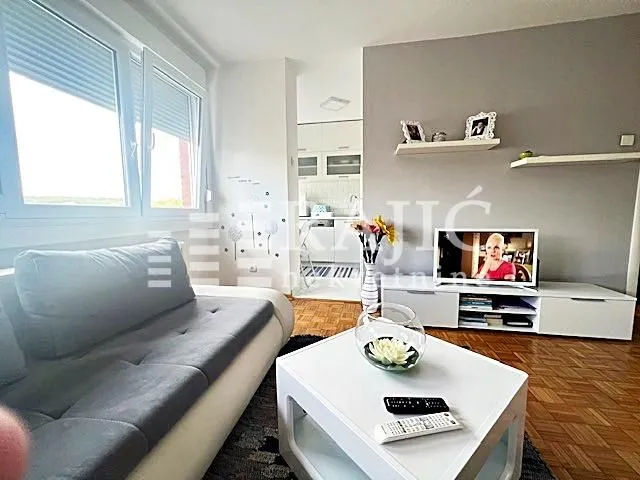 Living room with sofa, coffee table and TV unit.