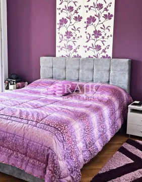 Bedroom with a double bed and purple details. - image 5