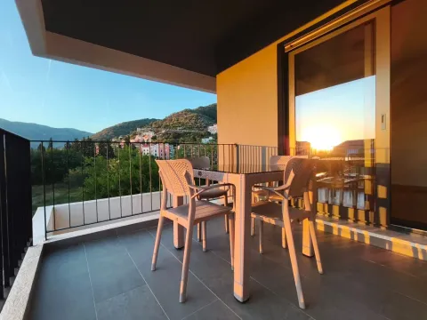 Covered terrace with a table, chairs, and a view of the surroundings. - image 7
