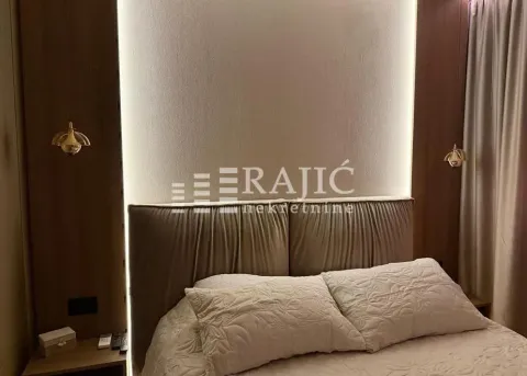 Modern bedroom with a double bed and decorative lighting. - image 10