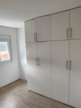 Bright room featuring a large built-in wardrobe next to a window. - image 7