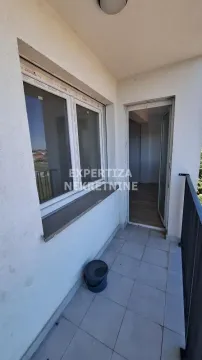 Small enclosed balcony with tiled flooring and a doorway leading inside. - image 8