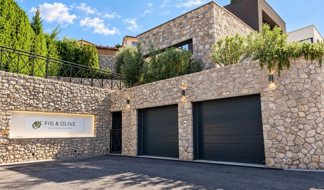 Building exterior with stone facade and garage doors.