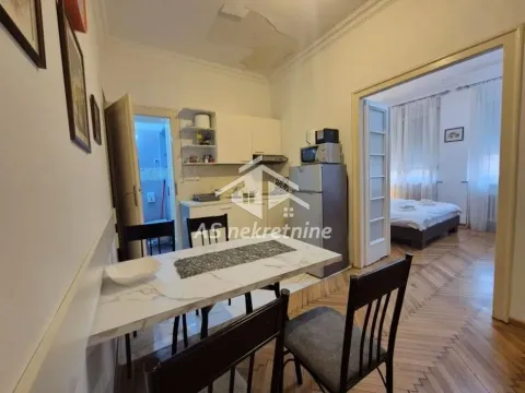 Small kitchen with a dining table and a view into the bedroom. - image 6