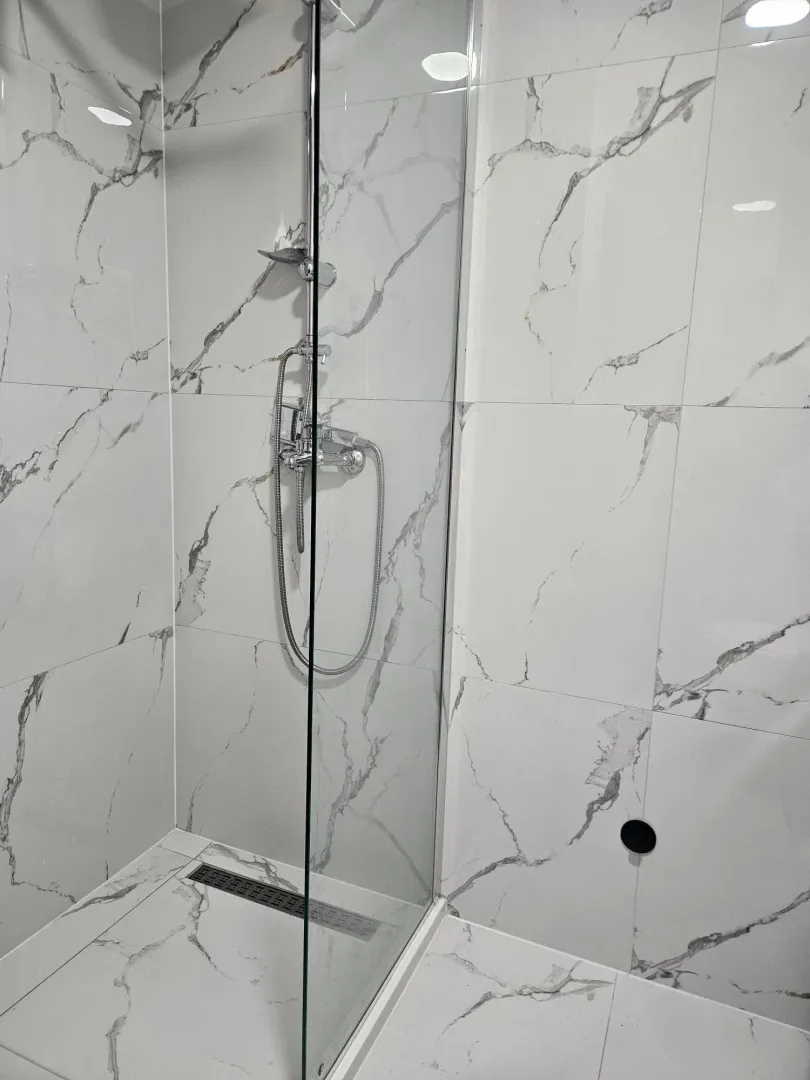 Modern tiles and shower cabin in the bathroom.