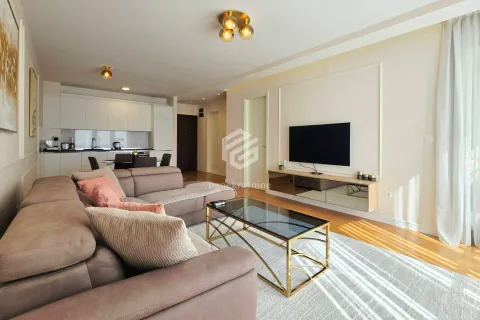 Living room with sofa, TV and dining area in the background. - image 6