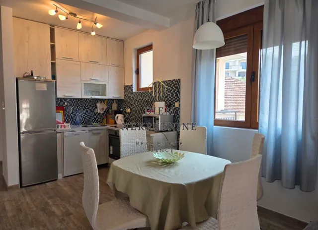 Small kitchen with a dining table and chairs.
