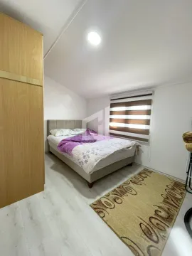 Furnished bedroom with a double bed, wardrobe, and window. - image 7