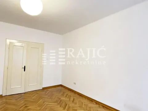 Empty room with white walls and parquet flooring. - image 3