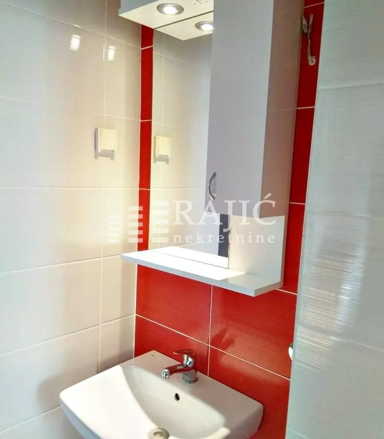 View of the sink and mirror in the bathroom.
