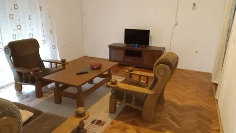 Living room with wooden furniture, a coffee table, and a TV. - image 3