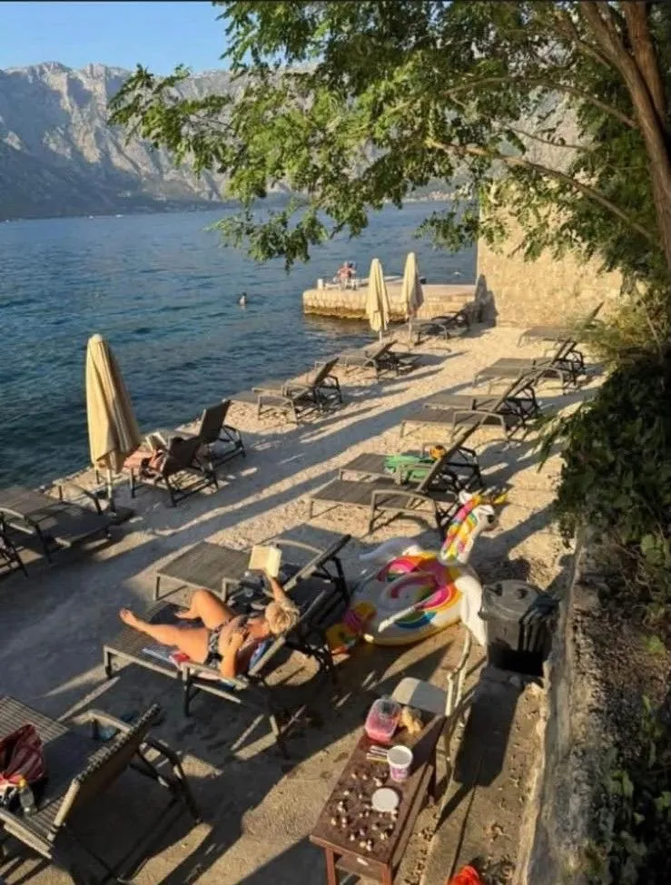 Plaža sa ležaljkama i pogledom na more.