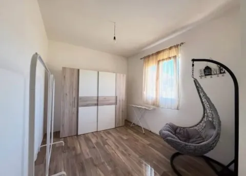 Furnished bedroom with a wardrobe and hanging chair. - image 9