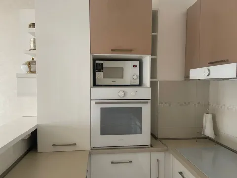 View of a kitchen section with built-in oven, microwave, and cabinetry. - image 4